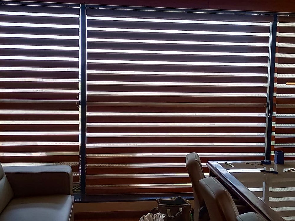 Zebra blinds across an office cabin window wall in Surat