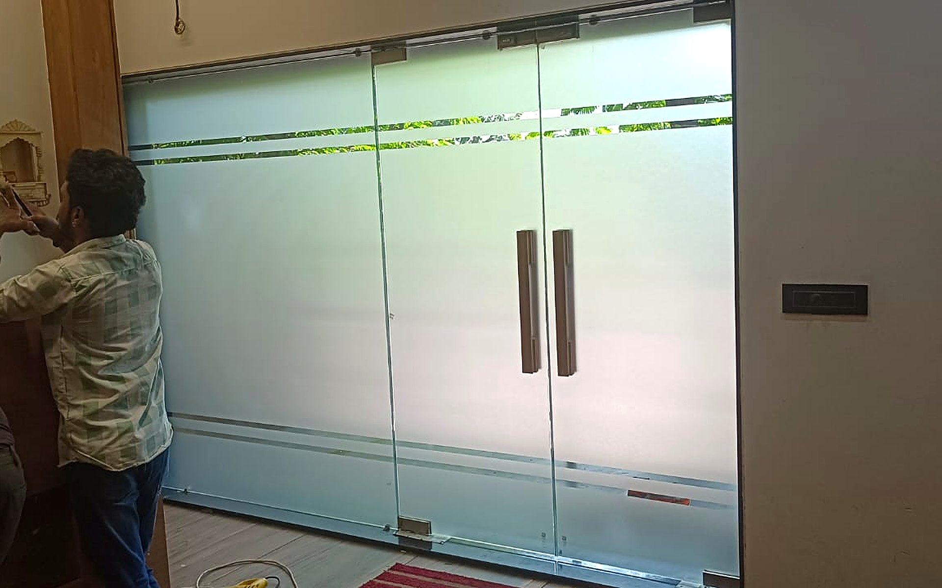 Royal Decor team applying frosted glass film to office doors in Surat
