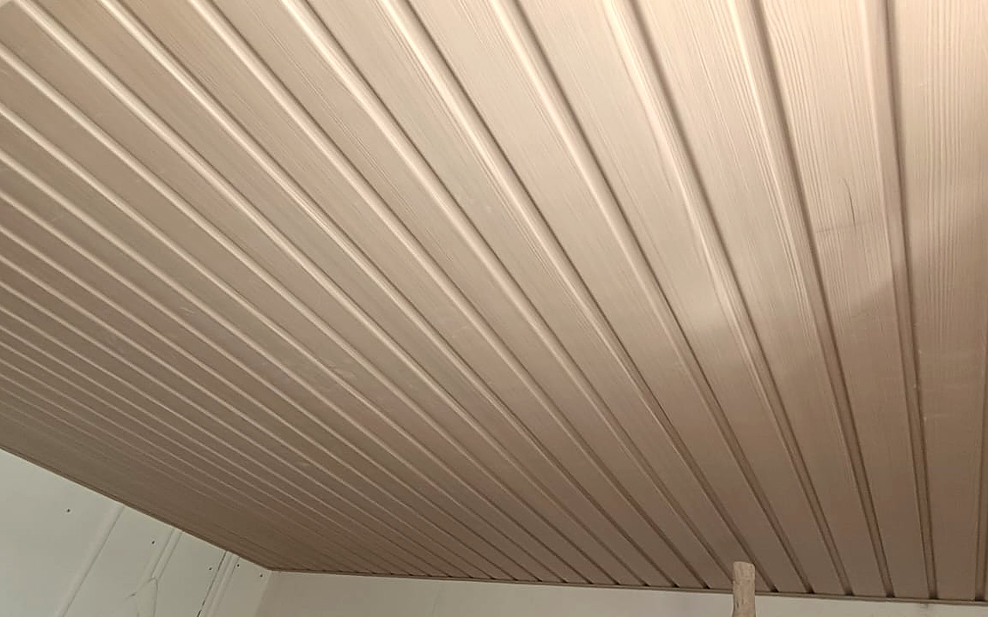 Soffit panel ceiling in a wood finish installed in Surat by Royal Decor