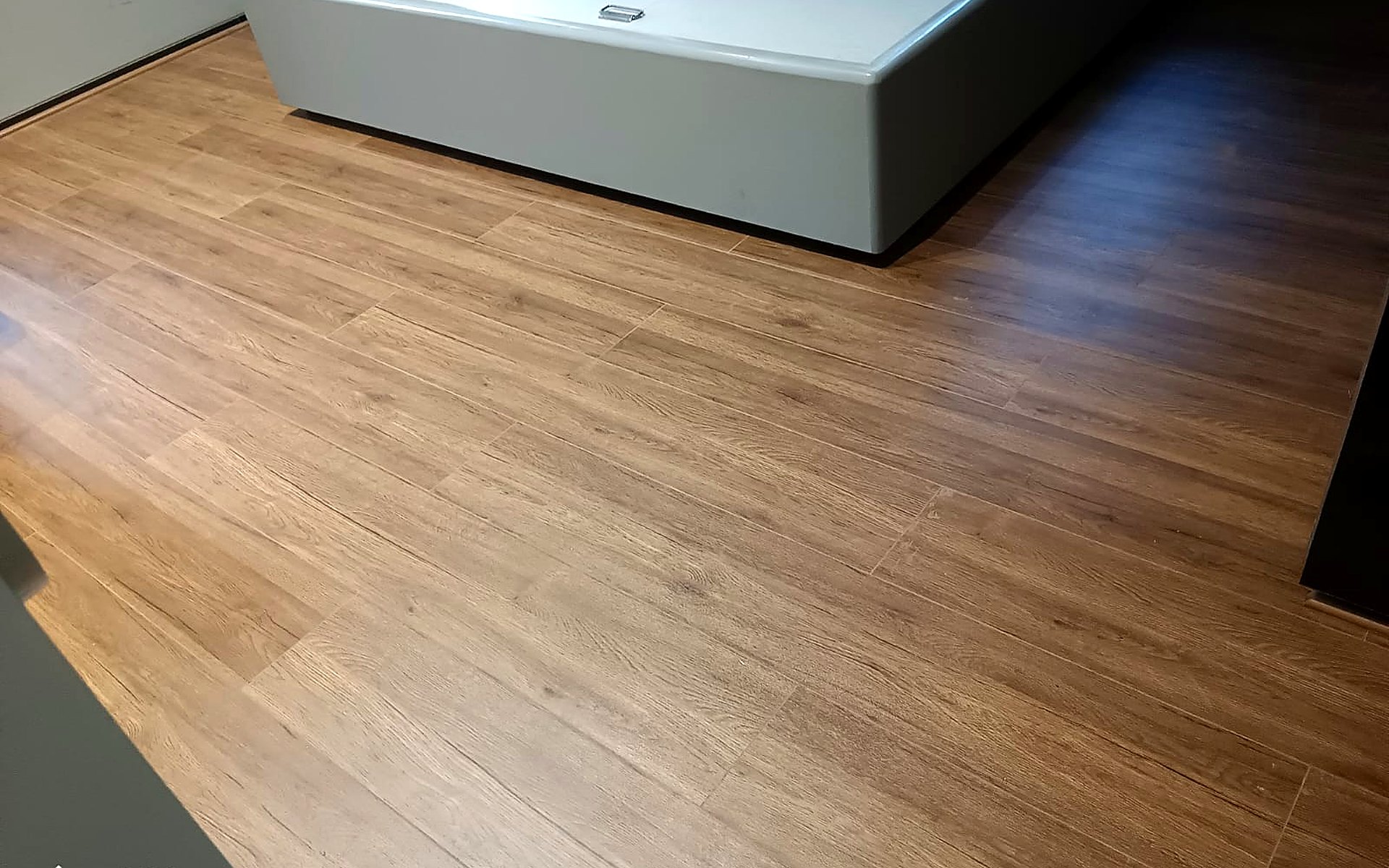 Laminate wooden flooring installed in a bedroom in Vesu, Surat